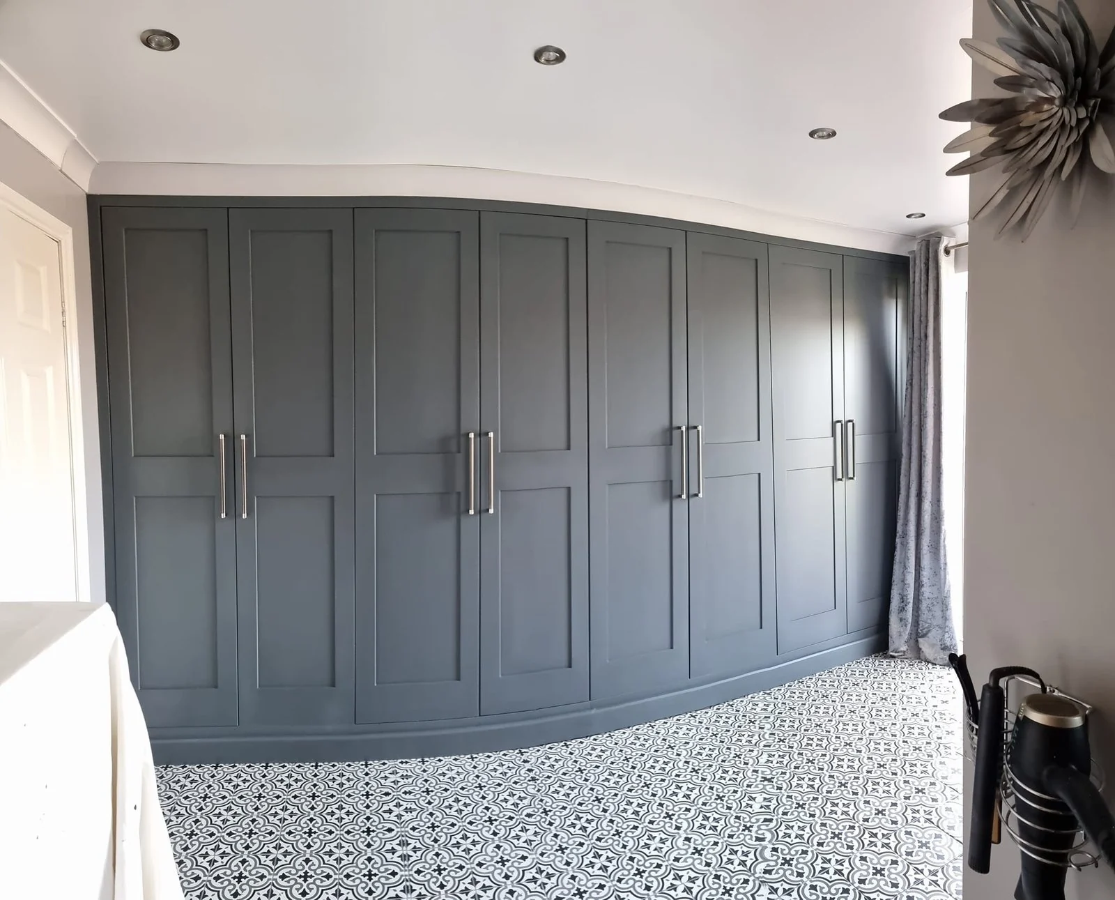Full wall of dark grey fitted bedroom wardrobes