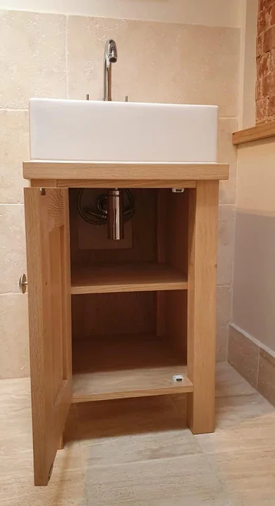 Natural wood vanity cabinet with square white basin