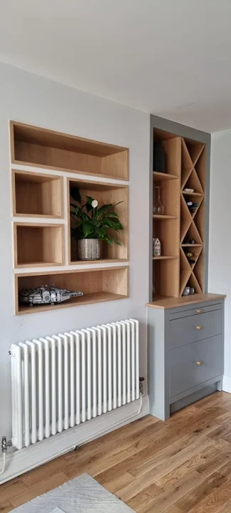 Painted alcove storage with natural oak shelves and wine rack